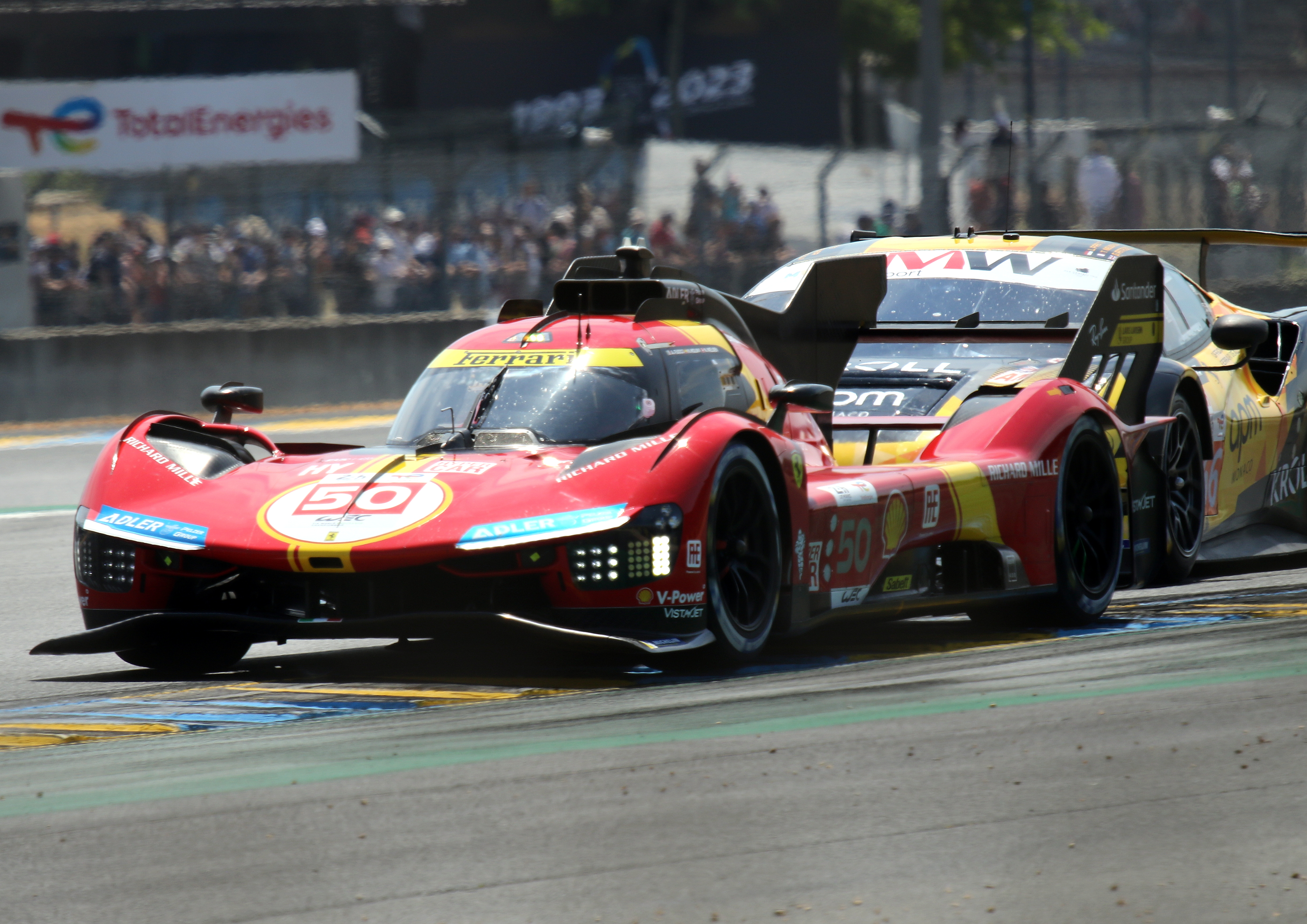 Ferrari 499P Hybrid - Antonio Fuoco, Miguel Molina & Nicklas Nielsen exits Dunlop Chicane at the 2023 Le Mans (53367113770).jpg